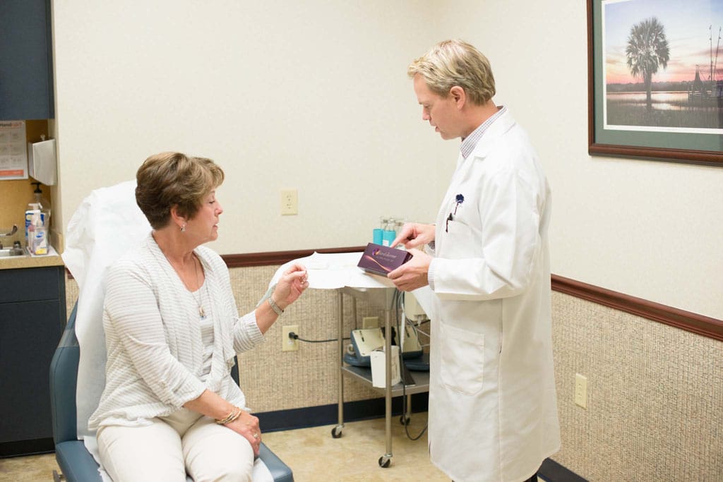 Doctor showcasing Juvederm product package