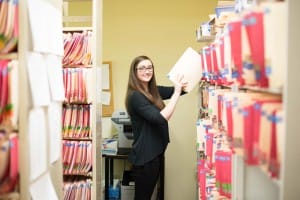 Administrative assistant filing folders