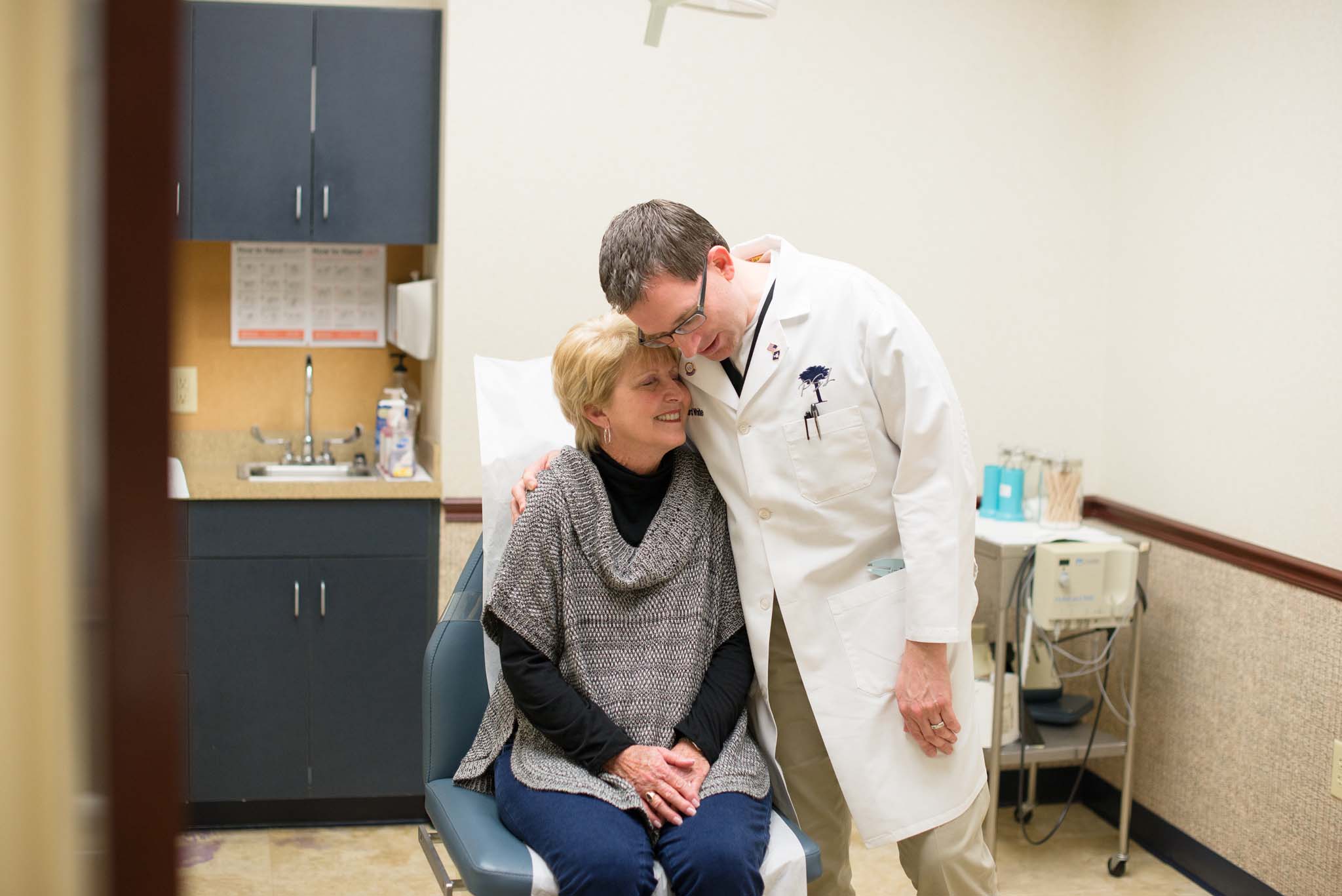 Doctor hugging patient