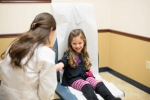 Child in doctors chair receiving dermotological care