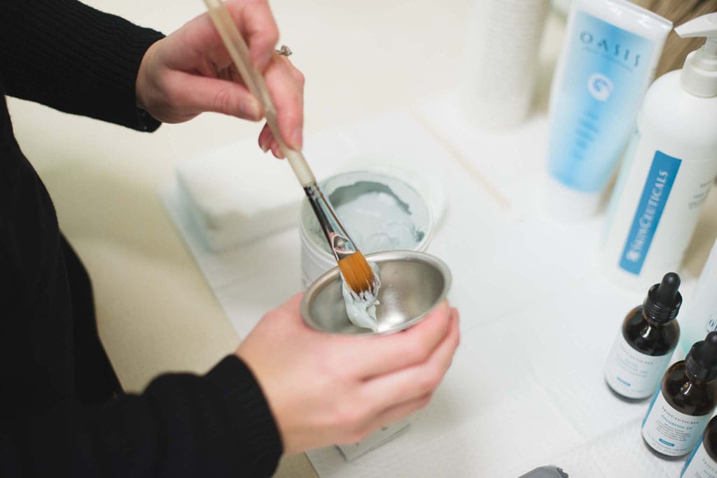 Brush mixing skin care product in ramakin