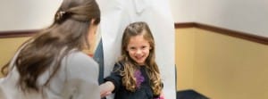 Child in doctors chair receiving dermatological care