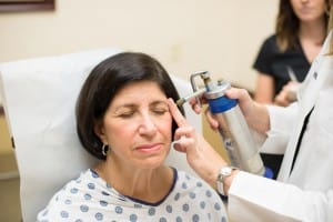 Patient receiving facial treatment